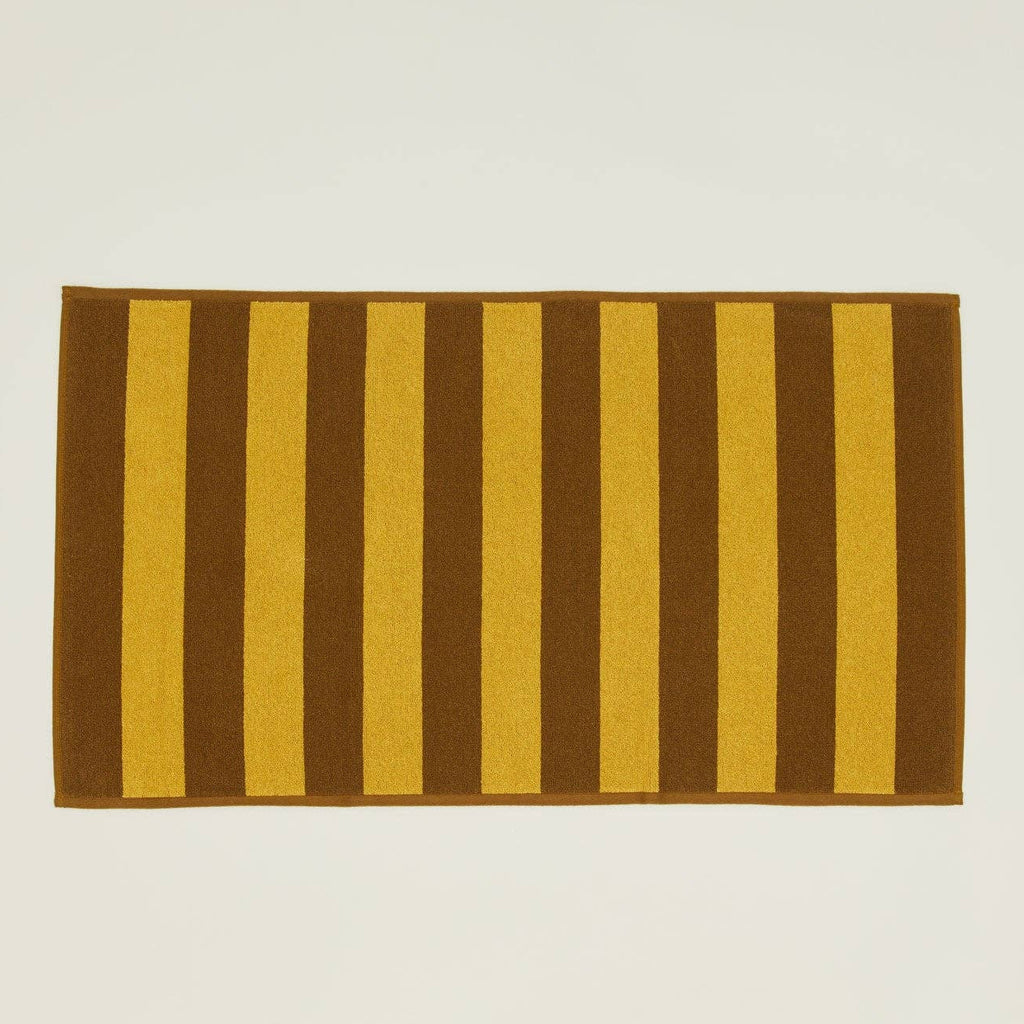 striped {mustard/bronze} bath mat