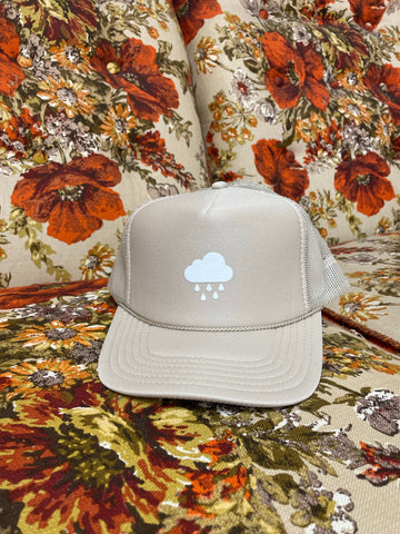 white rain cloud on tan trucker hat